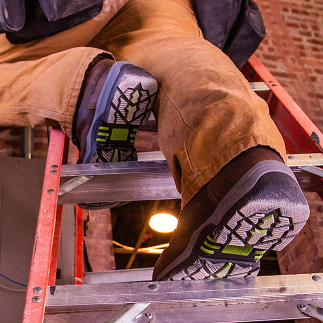 A man wearing the Fabricator 6" Waterproof Comp Toe Hiker boots in brown.